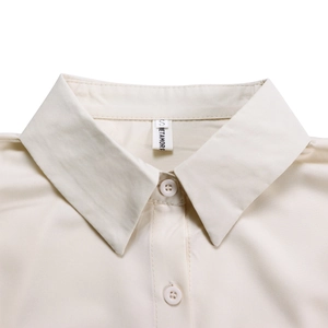 Detail view of the beige linen shirt collar with precise stitching and S size label