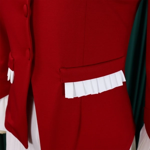 Close-up of red blazer featuring white pleated hem details and matching fabric buttons