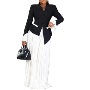 Detailed view of women's black blazer featuring layered white ruffle trumpet cuffs and pants