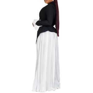 Detail of elegant bell sleeves with pleats and high-low hem on a two-piece set