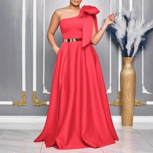 Detail of elegant red one-shoulder evening gown with large bow and gold metal belt