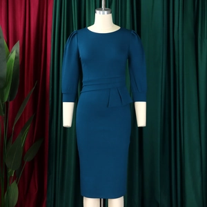 Detailed view of the ruffle waist design and puff sleeves on a teal OL sheath dress