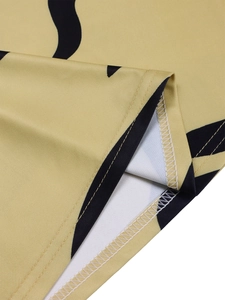 Detail of yellow floral print fabric showing high-quality stitching and hem finish