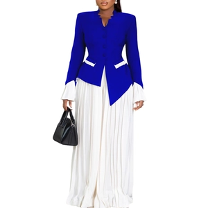 Detailed view of dark blue blazer with pleated white hem and matching wide leg pants