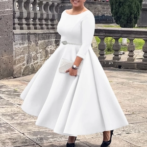 Detail of white A-line evening dress with long sleeves and beaded waist belt