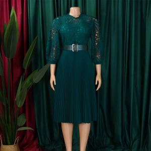 Detail of elegant dark green lace bodice and pleated skirt with vintage lantern sleeves