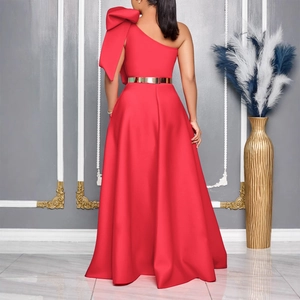 Detail of red one-shoulder evening gown with large bow and gold metal belt on satin dress