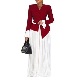 Detail of burgundy flared sleeve top paired with white pleated wide leg trousers