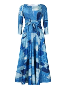 Detail view of the digital denim patchwork print and waist tie on the flared midi dress