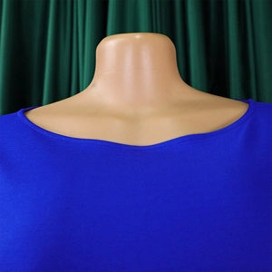 Detail view of the royal blue round neckline and fabric texture on a solid color dress