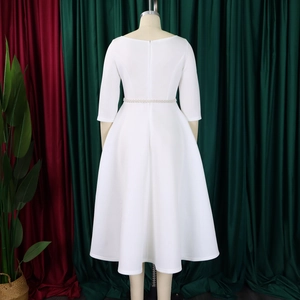 Detail of elegant white evening dress with pearl belt and A-line silhouette back view