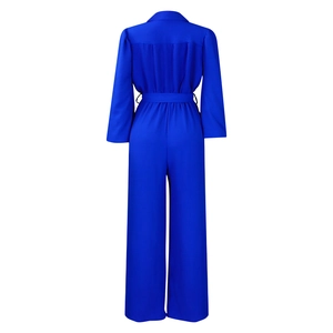 Rear view detail of royal blue long sleeve jumpsuit with waist tie and wide-leg cut