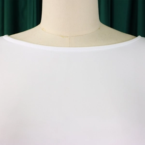 Close-up of the elegant neckline and high-quality stitching on a white evening dress