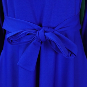 Close-up of royal blue knitted dress detail showing texture and elegant waist bow tie