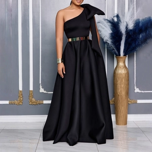 Detail of elegant one shoulder evening gown featuring a large 3D bow and gold mirror belt