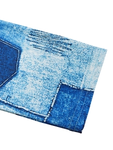 Detail of blue denim print fabric with color block stitching and double needle hem