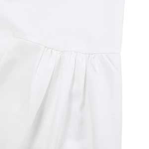 Close-up detail of pleated design on white loose fit asymmetrical midi dress fabric