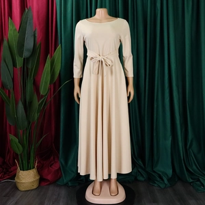 Detail of beige long-sleeve pleated maxi dress featuring a matching waist bow tie