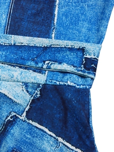 Detail of waist pleats and denim patchwork print on a stylish blue midi dress