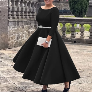Detail of elegant black A-line midi dress with sparkling diamond waist belt and long sleeves