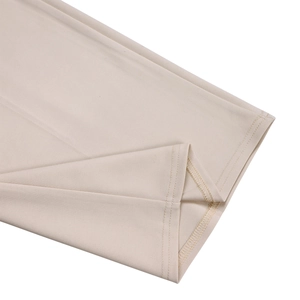 Detailed close-up showing the professional stitching and hem of beige wide leg jumpsuit