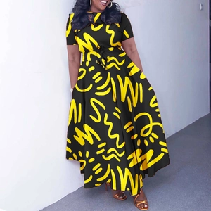 Detail of African print dress featuring yellow abstract patterns and a waist tie belt