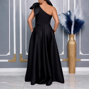 Elegant black one-shoulder satin evening gown with large artistic bow detail