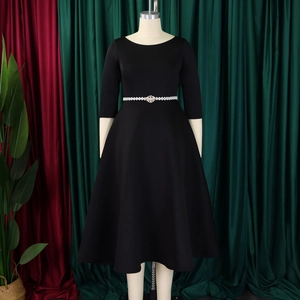 Detail of elegant black A-line dress with pearl and rhinestone belt and 3/4 sleeves