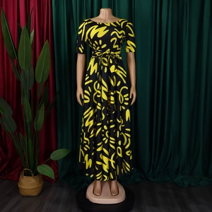 Detail of summer dress featuring black fabric with vibrant yellow abstract graffiti prints