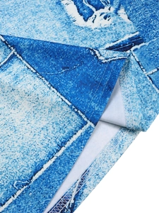 Close-up of faux denim digital print fabric with white geometric patterns and stitching