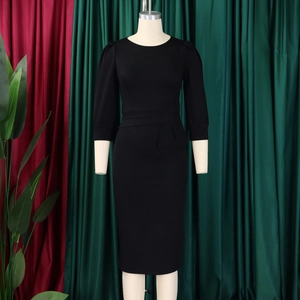 Detail of black pencil dress with round neck, puff sleeves and pleated side panel
