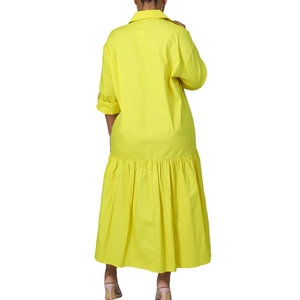 Detail view of the yellow long-sleeve dress with pleated hem and flared silhouette