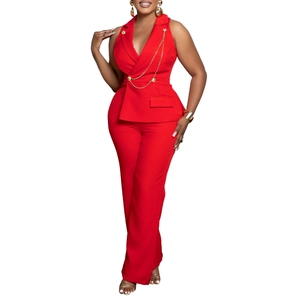Detail of red vest suit featuring elegant gold chain accents and double-breasted buttons