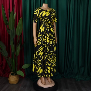 Detail of African print maxi dress with yellow abstract pattern and waist tie belt