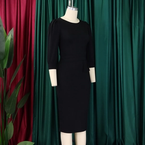 Detailed view of black bodycon dress with French puff sleeves on a display mannequin