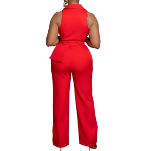 Detail view of red sleeveless jumpsuit with asymmetric ruffle and wide leg from behind