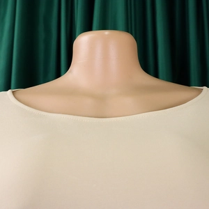 Detail of beige round neck dress showing high-elasticity knit fabric and double-needle sewing