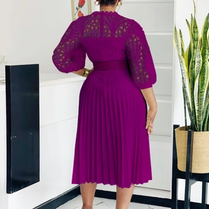 Detailed view of the purple lace hollow out embroidery and pleated hem of the dress