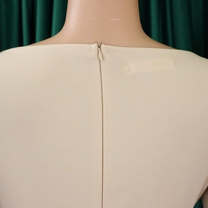 Detail view of the back invisible zipper on a beige elegant African style dress
