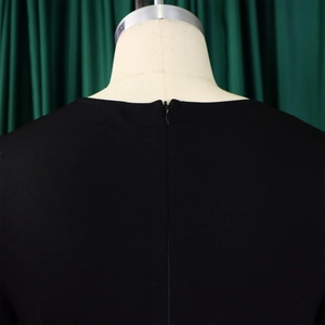 Close-up of the invisible zipper on the back of this elegant black plus size dress