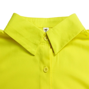 Macro view of neon yellow cotton shirt collar with matching buttons and size S tag