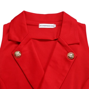 Detail of red blazer collar with gold embossed buttons and METAMORPHOSIS GIRL brand label