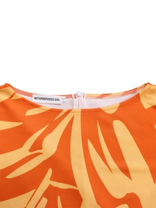 Detail of printed knit dress neckline with hidden white zipper and abstract patterns