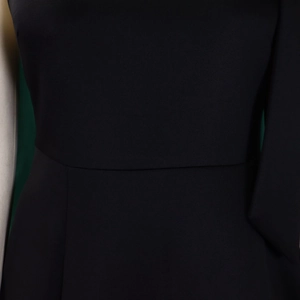 Detailed view of the waist seam and smooth fabric texture on the elegant black dress