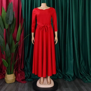 Detailed view of red long sleeve dress with waist tie and round neckline on a mannequin