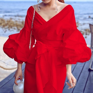 Red V-neck top with puff sleeves and oversized waist bow detail for elegant vacation style