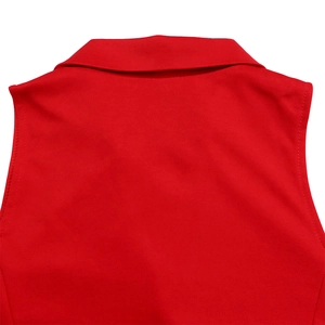 Detailed close-up of the red sleeveless jumpsuit lapel collar and fine knit stitching