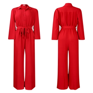 Front and back view of red long sleeve wide leg jumpsuit with waist belt detail