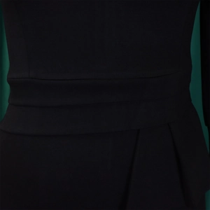 Close-up of elegant pleated waist detail on a black bodycon dress with intricate folds