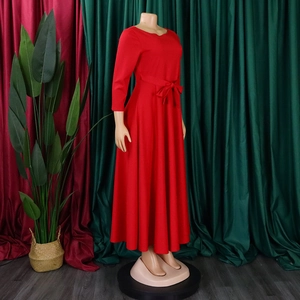 Detailed view of the waist tie bow and flare hem of this red A-line long dress